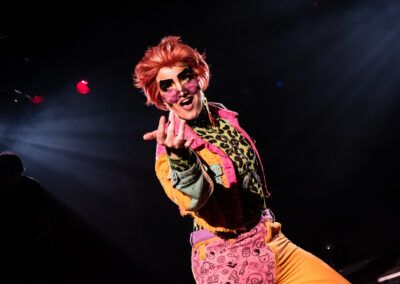 Cyril Cinder in colourful outfit and makeup.