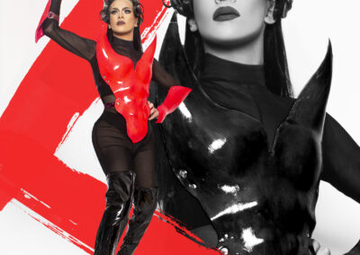 Dramatic poster of Vanity Affair wearing a black and red armour-style outfit.