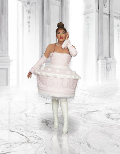 Dulce wearing a very pale pink cake dress with white tights and matching pale pink gloves.
