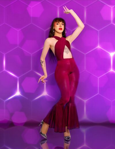 Nicki Nastasia wearing a red velvet bodysuit, posing like a flamenco dancer.