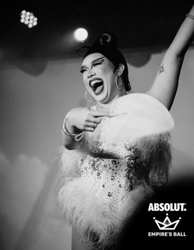 Black and white photo of Star performing in a white rhinestone and feather corset.