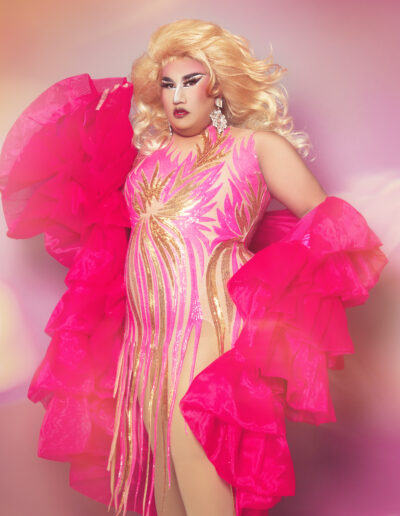 Dulce in a shimmery pink fringed bodysuit and ruffled hot pink robe.