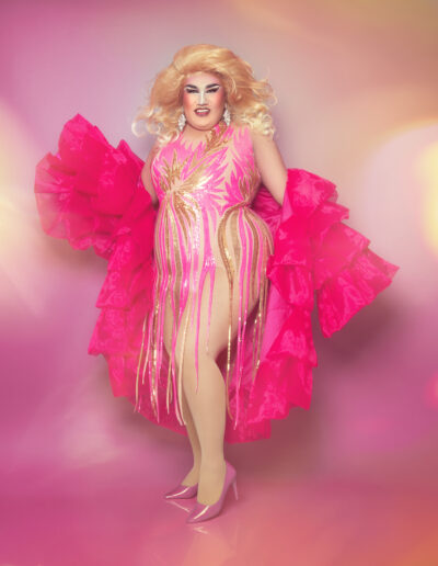 Dulce wearing a pink fringed bodysuit with ruffled bright pink robe.