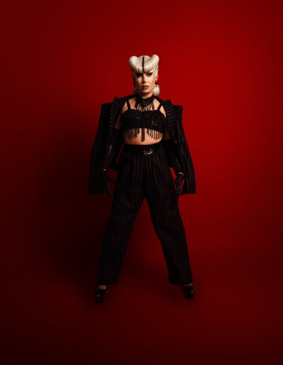 Bust-up view of Vanity Affair in a blue vinyl nurse costume.